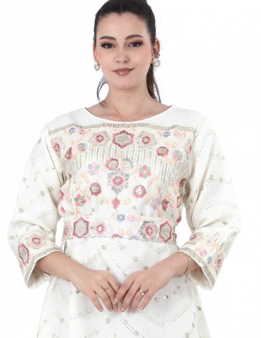White jalabiya with colorful embroidery.