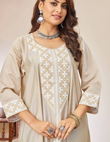 Beige jalabiya with white embroidery.