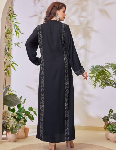 Black jalabiya with geometric embroidery.